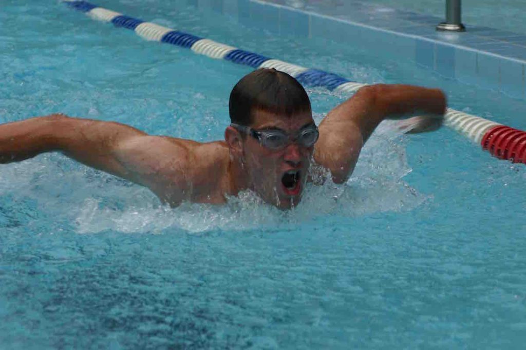 Swimmer in full stretch butterfly
