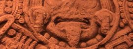 Aztec stone with figure having tongue stuck out