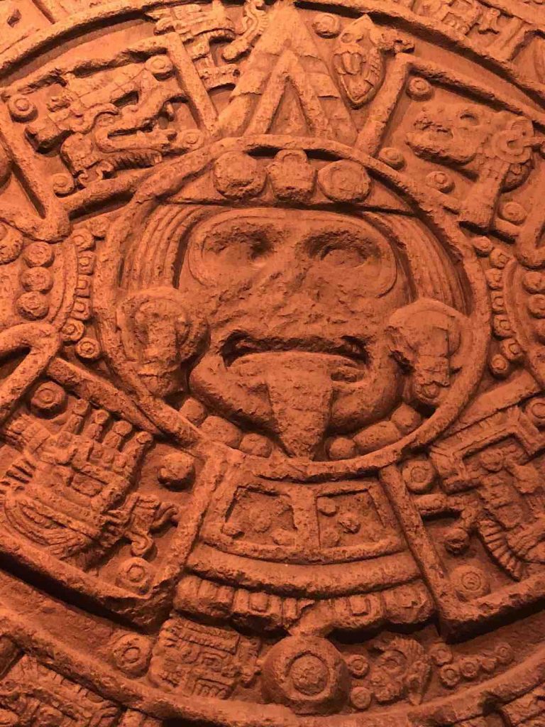Aztec stone with figure having tongue stuck out
