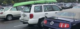 Kayak on top of car at super market before storm