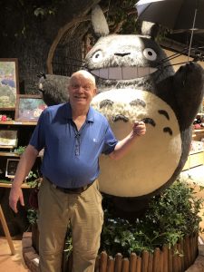 Author with giant stuffed panda like creature.
