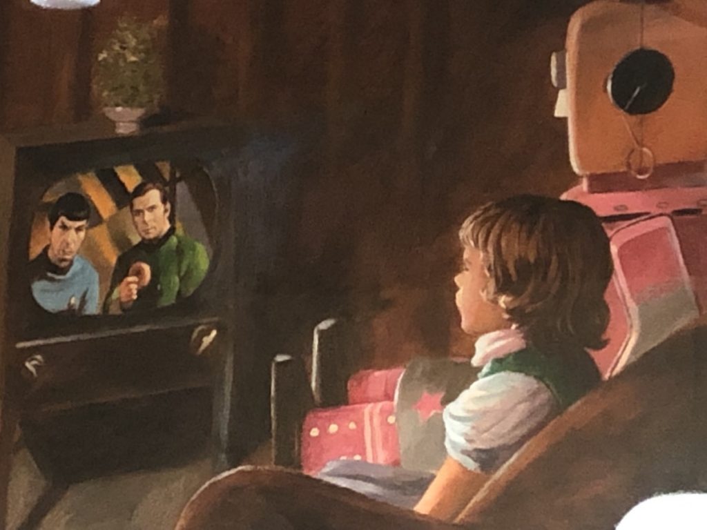 picture of robot babysitting little girls watching TV with StarTrek. Spock and Kirk are on the screen. Kirk is holding a donut.