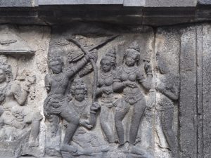 bas-relief panel of an archer and dancers