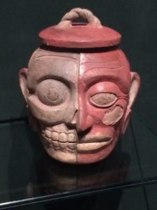 Jug with a face: half skull, half flesh