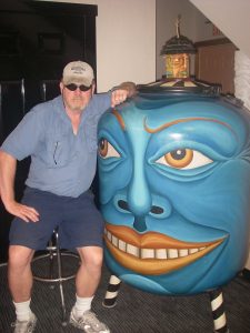 Author with large blue headed sculpture at Ben and Jerry's Ice Cream HQ