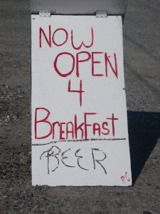 Sign reads:
"Now Open 4 Breakfast"
below which is written
"BEER"